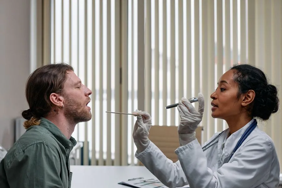 A doctor examining a patient's throat