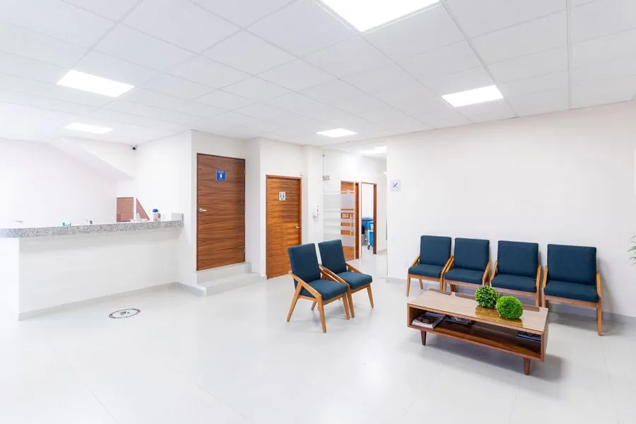 A clean, well-lit clinic waiting room with chairs