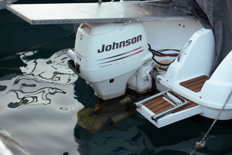 A Johnson outboard motor on the back of a white boat